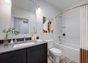 Thumbnail 4 of 73 - A bathroom with a white toilet, a sink, and a bathtub. at The MK, Indianapolis, 46220