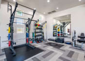Thumbnail 26 of 43 - a fitness center with weights and equipment on the wall at Discovery at Craig Ranch, McKinney, TX