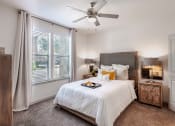 Thumbnail 33 of 43 - a bedroom with a large bed and a ceiling fan at Discovery at Craig Ranch, McKinney, Texas