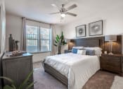 Thumbnail 34 of 43 - a bedroom with a bed and a ceiling fan at Discovery at Craig Ranch, McKinney, TX