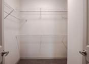 Thumbnail 35 of 43 - a walk in closet with empty shelves in a white room at Discovery at Craig Ranch, McKinney, Texas