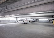 Thumbnail 10 of 43 - Parking garage with cars parked at 747 Apartments, Indianapolis, Indiana