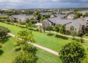 Thumbnail 40 of 47 - A suburban neighborhood with houses and green lawns at Avenues at Shadow Creek Ranch Apartments, Pearland, TX, 77584