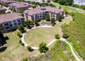 Thumbnail 40 of 43 - an aerial view of a building with a yard and a pathway at Discovery at Craig Ranch, Texas, 75070