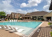 Thumbnail 30 of 47 - Swimming pool with lounge chair at Grand Villas at Cinco Ranch, Katy, 77494