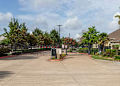 Thumbnail 38 of 47 - Sunny day at the entrance of a gated community at Grand Villas at Cinco Ranch, Texas