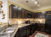Thumbnail 5 of 47 - Kitchen with cabinets at Grand Villas at Cinco Ranch, Texas, 77494