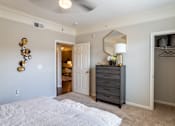 Thumbnail 24 of 47 - Bedroom with a mirror at Grand Villas at Cinco Ranch, Katy, TX