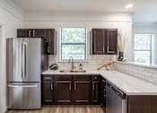 Thumbnail 8 of 47 - Kitchen with stainless steel refrigerator at Grand Villas at Cinco Ranch, Katy, Texas