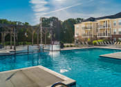 Thumbnail 3 of 61 - pool with apartment building in the back at The Greyson, Hilliard