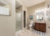 Thumbnail 47 of 61 - shower and sink vanity in bathroom at The Greyson, Hilliard