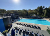 Thumbnail 5 of 21 - an aerial view of a swimming pool and deck with chairs at The Boulevard, Roeland Park, KS
