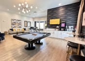 Thumbnail 1 of 38 - a game room with a pool table in the center of it at Waterstone at Cinco Ranch, Katy, TX, 77450