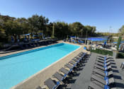 Thumbnail 4 of 21 - an aerial view of a swimming pool with lounge chairs at The Boulevard, Roeland Park, KS