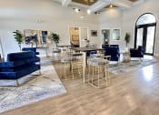 Thumbnail 4 of 38 - a living room with blue couches and chairs and a table with chairs at Waterstone at Cinco Ranch, Katy, TX, 77450