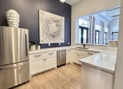 Thumbnail 8 of 38 - a kitchen with white cabinets and a stainless steel refrigerator at Waterstone at Cinco Ranch, Katy, TX, 77450