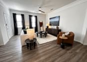 Thumbnail 41 of 84 - a living room with a couch and a table at Grand Villas Apartments, Katy