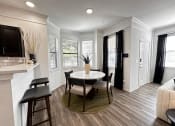 Thumbnail 27 of 84 - a kitchen and dining room with a table and chairs at Grand Villas Apartments, Katy