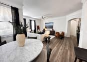 Thumbnail 4 of 84 - a living room and dining room with a marble table at Grand Villas Apartments, Katy