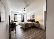 Thumbnail 33 of 84 - a bedroom with a bed and a ceiling fan at Grand Villas Apartments, Katy
