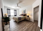 Thumbnail 40 of 84 - a bedroom with a bed and a ceiling fan at Grand Villas Apartments, Katy