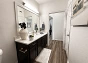 Thumbnail 42 of 84 - bathroom with a large mirror and a sink at Grand Villas Apartments, Katy