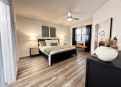 Thumbnail 43 of 84 - a bedroom with a bed and a ceiling fan at Grand Villas Apartments, Katy