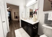 Thumbnail 38 of 84 - a bathroom with a large mirror and a sink at Grand Villas Apartments, Katy