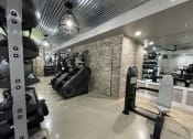 Thumbnail 22 of 63 - a gym with weights and other exercise equipment on a brick wall at Edge 35, Indianapolis