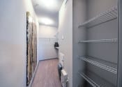 Thumbnail 35 of 38 - a walk in closet with empty shelves and a closet door  at Waterstone at Cinco Ranch, Katy, 77450