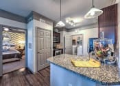 Thumbnail 29 of 38 - a kitchen with a counter top and a fish tank  at Waterstone at Cinco Ranch, Texas