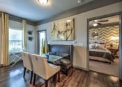 Thumbnail 34 of 38 - a living room with a table and chairs and a bedroom  at Waterstone at Cinco Ranch, Katy