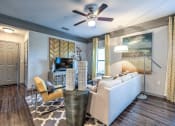 Thumbnail 32 of 38 - a living room with a couch and a ceiling fan at Waterstone at Cinco Ranch, Katy, TX