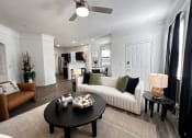Thumbnail 2 of 84 - a living room with a couch and a coffee table at Grand Villas Apartments, Katy