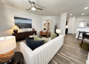 Thumbnail 5 of 84 - a living room with a couch and a ceiling fan at Grand Villas Apartments, Katy