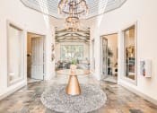 Thumbnail 33 of 38 - a foyer with a round table and a chandelier at River Pointe, Conroe, TX, 77304