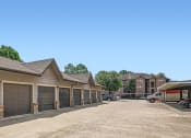 Thumbnail 31 of 38 - a parking lot with a row of garage doors at River Pointe, Conroe, TX
