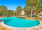 Thumbnail 3 of 38 - a swimming pool with palm trees and a resort style pool at River Pointe, Texas, 77304