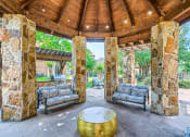 Thumbnail 26 of 38 - a covered patio with couches and a table at River Pointe, Texas