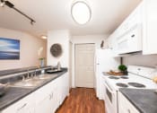 Thumbnail 25 of 27 - a kitchen with white cabinets and a white stove and a sink  at Butternut Ridge, North Olmsted