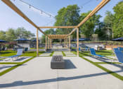 Thumbnail 15 of 27 - a large patio with lounge chairs and a fire pit  at Butternut Ridge, North Olmsted, OH