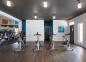 Thumbnail 20 of 27 - a gym with treadmills and other exercise equipment on a wooden floor  at Butternut Ridge, North Olmsted, 44070