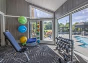 Thumbnail 18 of 27 - a home gym with a view of a swimming pool and glass doors  at Butternut Ridge, Ohio, 44070