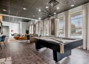 Thumbnail 2 of 28 - a game room with a pool table and windows at CityView, North Kansas City, Missouri
