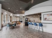 Thumbnail 5 of 28 - a large lobby with tables and chairs and a bar at CityView, North Kansas City, 64116