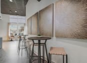 Thumbnail 12 of 28 - a seating area with stools and a table in a lobby at CityView, North Kansas City, MO