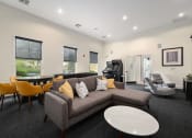 Thumbnail 25 of 39 - a living room with a couch and a table with chairs at Sovereign at Overland Park, Overland Park Kansas