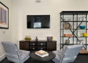 Thumbnail 27 of 39 - a lounge with a couch and a table and a television at Sovereign at Overland Park, Overland Park, KS 66213
