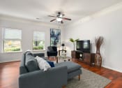 Thumbnail 7 of 39 - a living room with a couch and a ceiling fan at Sovereign at Overland Park, Overland Park, KS