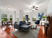 Thumbnail 5 of 39 - a living room with a couch and a ceiling fan at Sovereign at Overland Park, Kansas, 66213